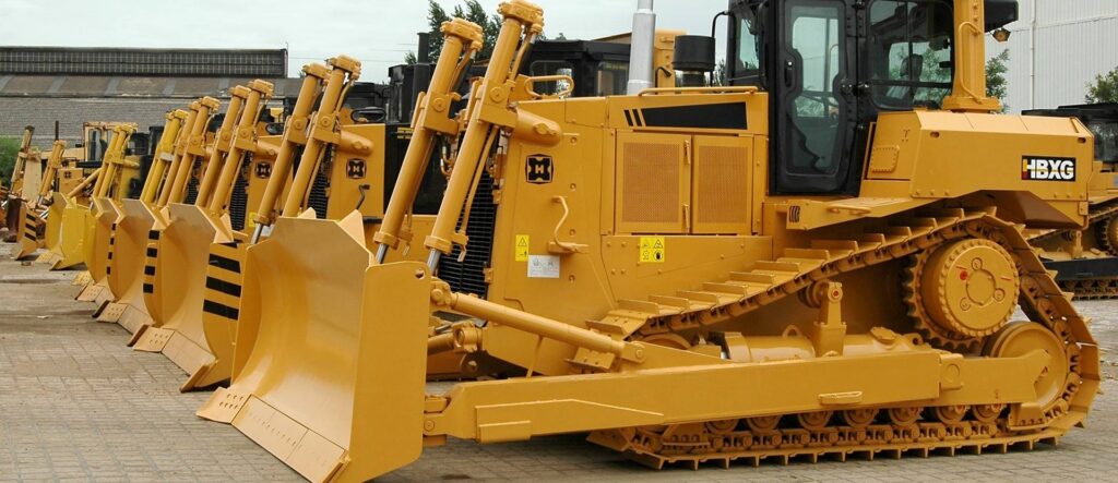 Row of yellow HBXG crawler bulldozers