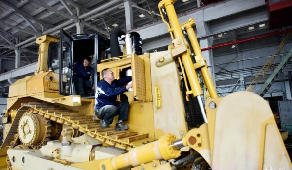 HBXG SD7 bulldozer undergoing maintenance with workers