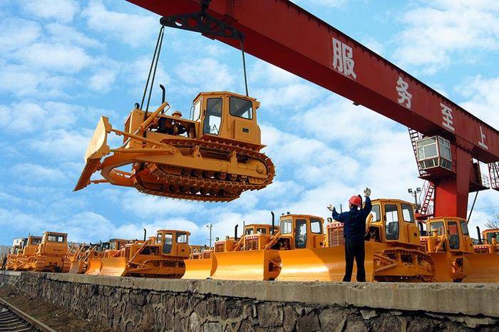 Row of yellow HBXG T165 bulldozers ready for delivery