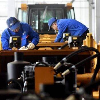 Technicians performing maintenance on HBXG T165 bulldozer
